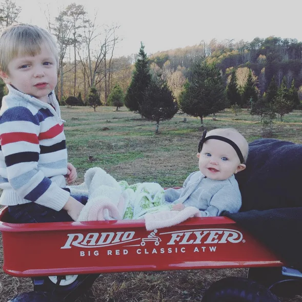 Visiting the Christmas tree farm and pulling the kids in a red wagon.