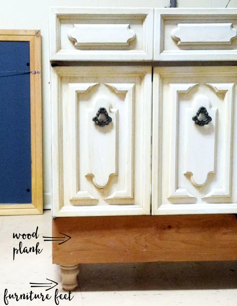 White cabinet that is in the process of being made taller for a bathroom vanity makeover. 