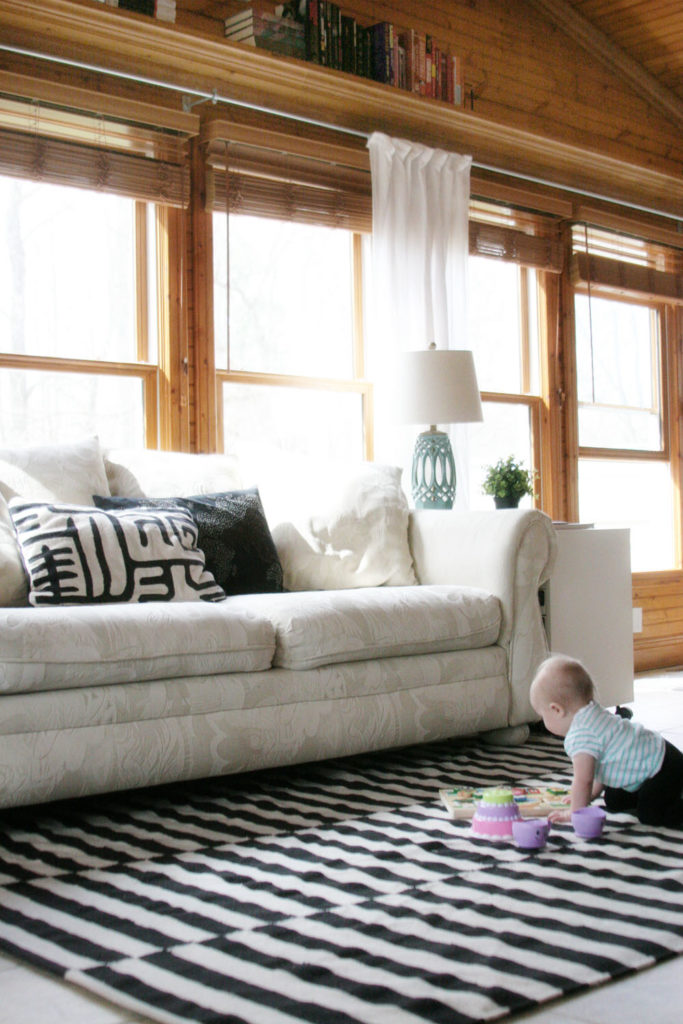 Choosing a Rug Pad for Tile Floors by @CraftivityD // Sunroom, Family Room, Black & White Rug