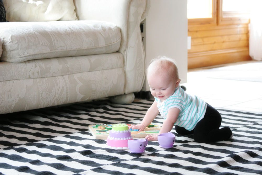 Choosing a Rug Pad for Tile Floors by @CraftivityD // Sunroom, Family Room, Black & White Rug