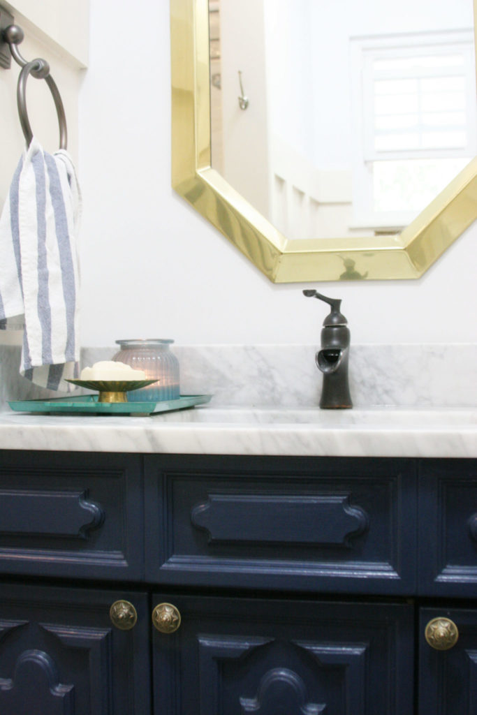 Navy and white bathroom renovation with vintage art, marble, board and batten. Ideas for a small bathroom or guest bath makeover. by @CraftivityD