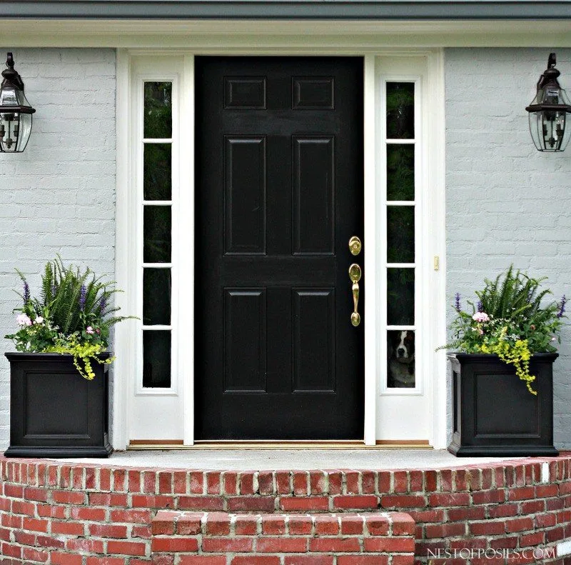 Painted brick exterior with a bold black door for a front door idea
