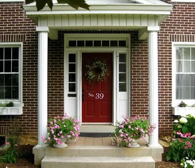 A home with brick exterior and a red door idea