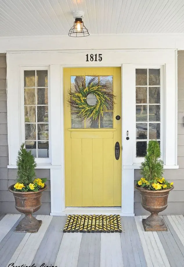 Grey siding with a yellow front door idea