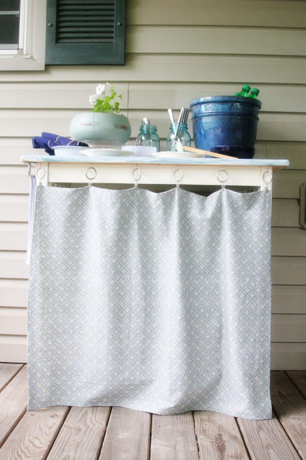 Make a DIY Outdoor Serving Bar from an inexpensive breakfast table. You