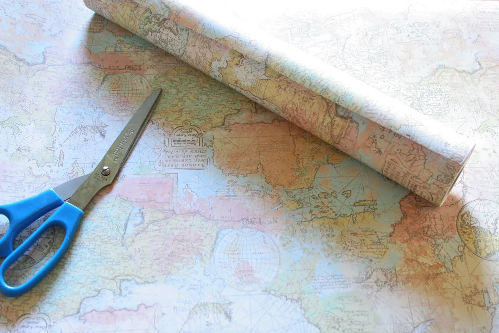 roll of decorative map paper with scissors