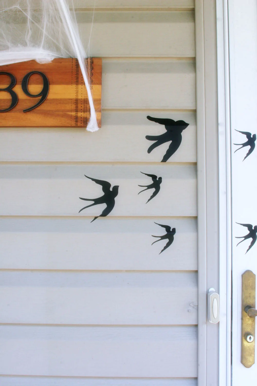 Flying bird adhesives on the side of a house used for DIY outdoor Halloween decorations
