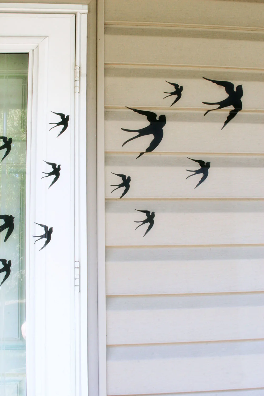 Bird adhesives on house as DIY outdoor Halloween decorations 