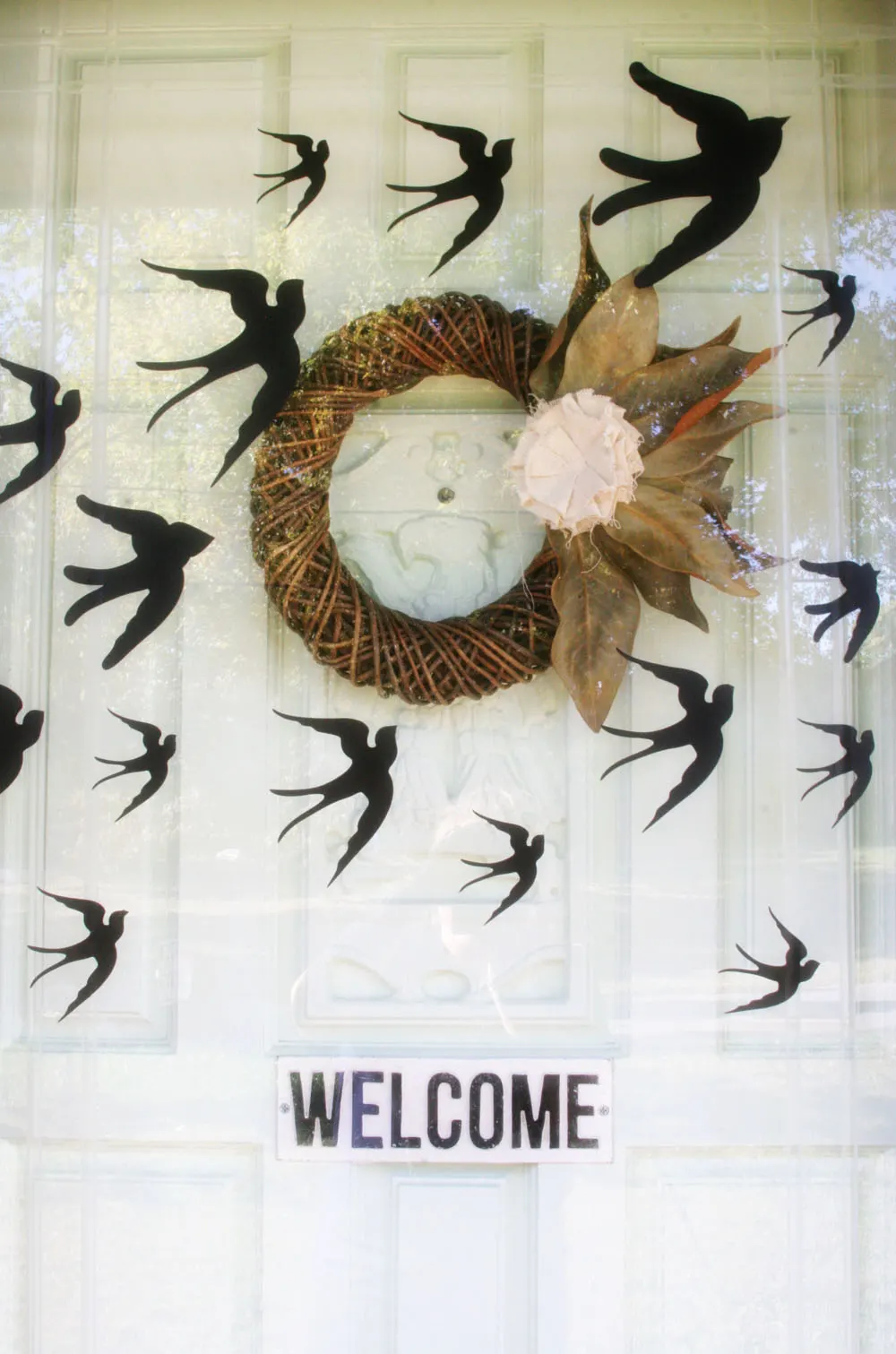 Fall wreath and flying bird adhesives used as DIY outdoor Halloween decorations
