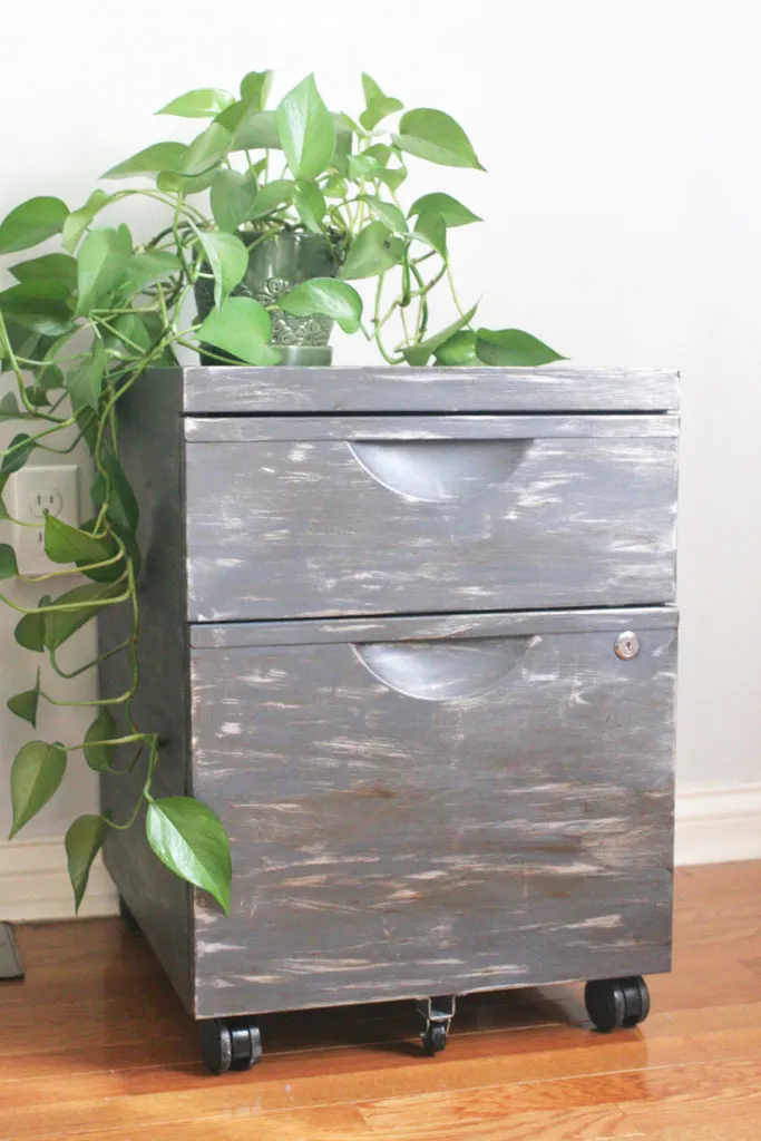 How to apply a faux zinc finish to a basic file cabinet for an rustic industrial makeover. Thrift store upcycle. Click the image to view the full tutorial with photos and paint colors.