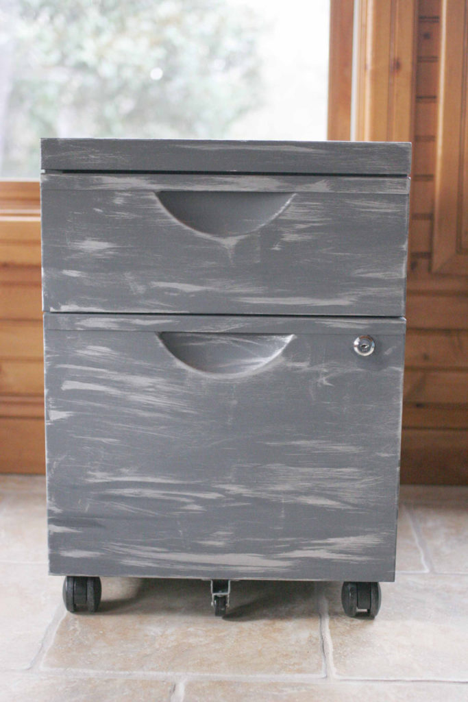 How to apply a faux zinc finish to a basic file cabinet for an rustic industrial makeover. Thrift store upcycle. Click the image to view the full tutorial with photos and paint colors.