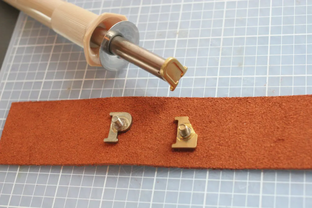 Learn how to make DIY Leather Drawer Pulls with labels on the pull for a child's bedroom. Click through for the full tutorial.
