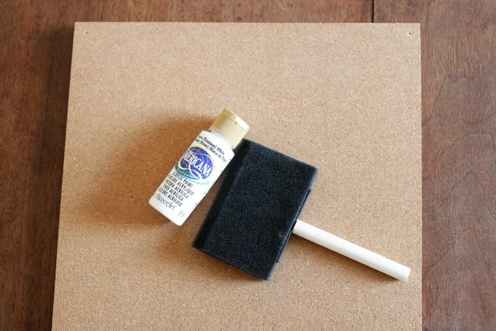 Foam paint brush, white craft paint and cork tiles for a Disney Countdown Calendar