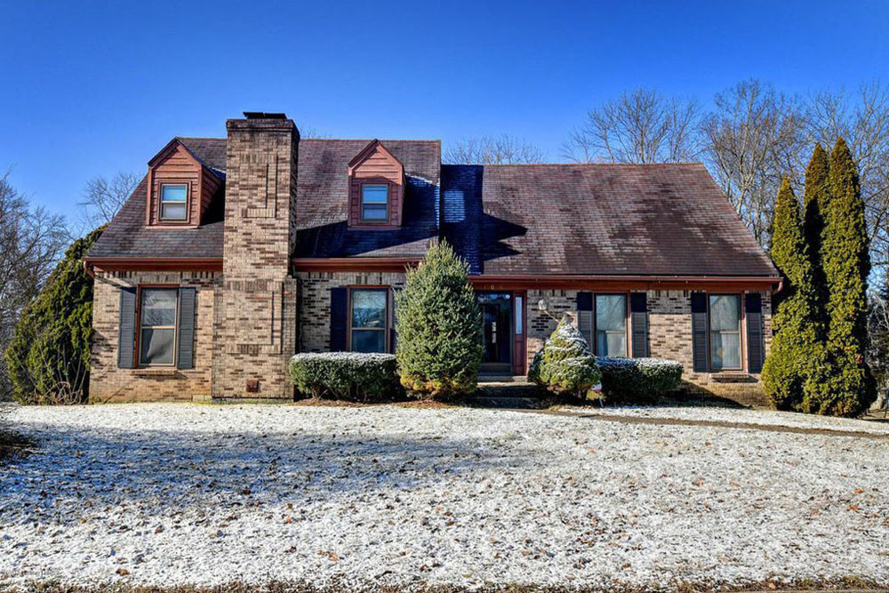 brick cottage style home, dormers, brick chimney