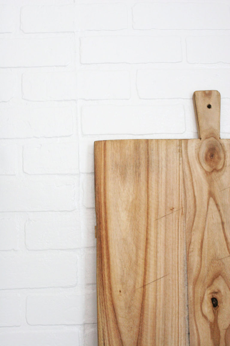 faux brick backsplash, wood bread board