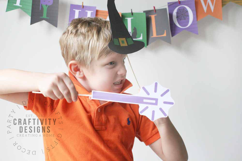 boy playing with printable halloween photo booth props
