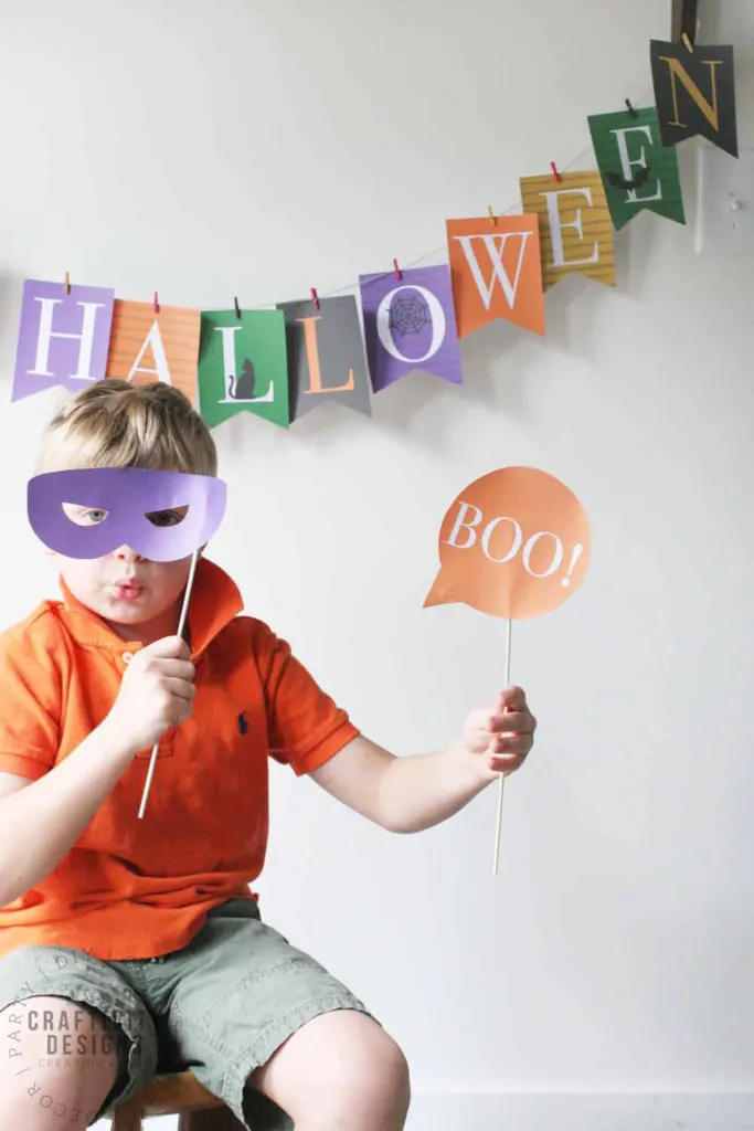 child playing with printable halloween photo booth props