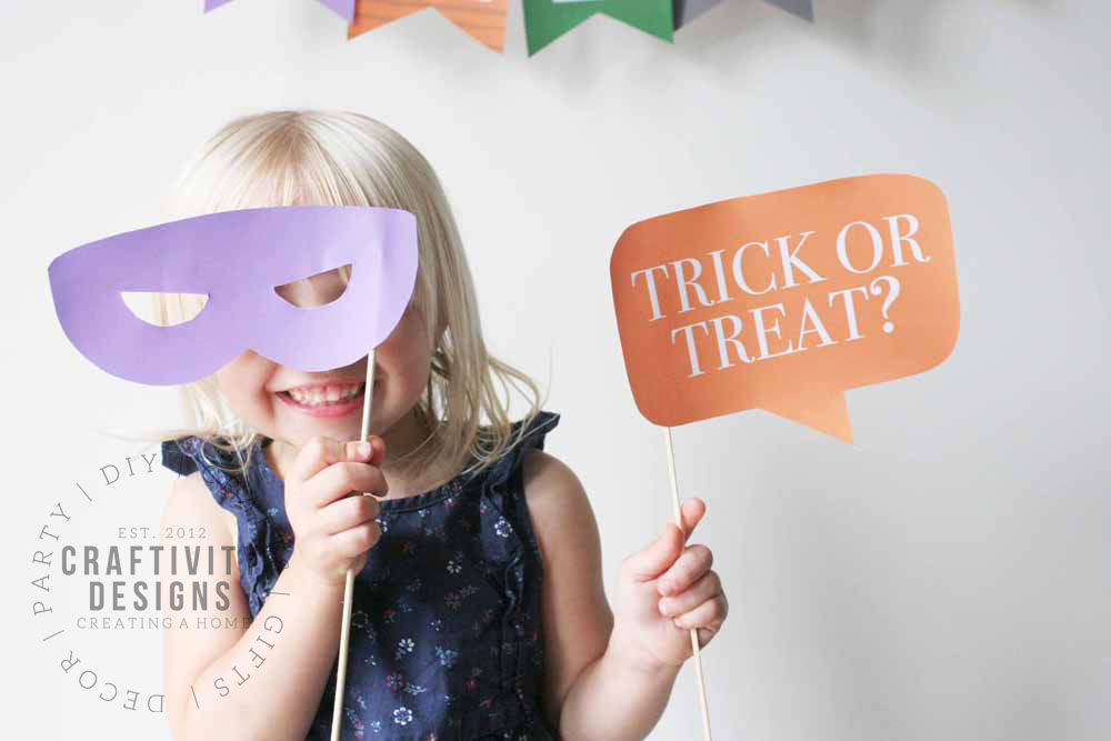 Child with Halloween Photo Booth Props: Mask and "Trick or Treat?" Bubble