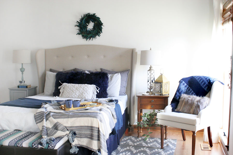 Eclectic Christmas Bedroom with Navy Bedroom Decor, White Walls, and Wood Trim