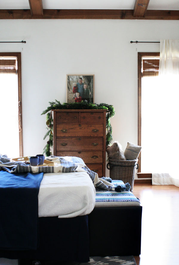 Eclectic Christmas Bedroom with Navy Bedroom Decor, White Walls, and Wood Trim