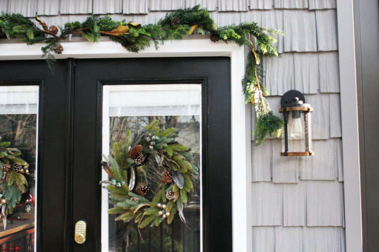 Black Door with Christmas Wreaths and Garland and Gray Cedar Shake Vinyl Siding