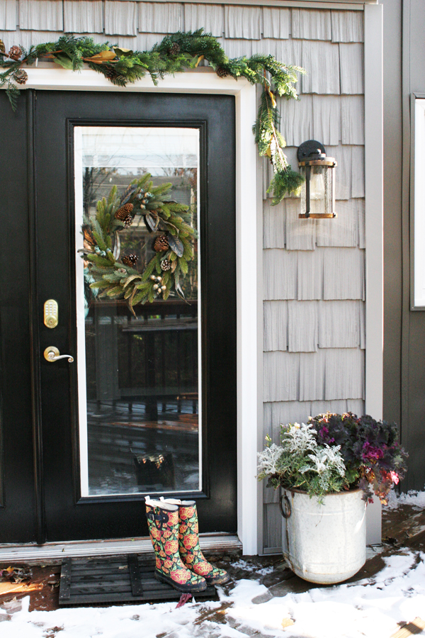 Black Door with Christmas Wreaths and Garland and Gray Cedar Shake Vinyl Siding