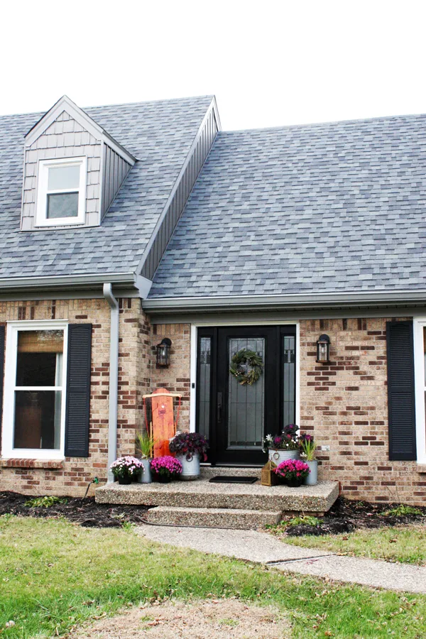 Brick Home with Black Front Door and Front Porch Christmas Decor