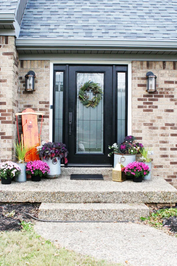Brick Home with Black Front Door and Christmas Front Porch Decor