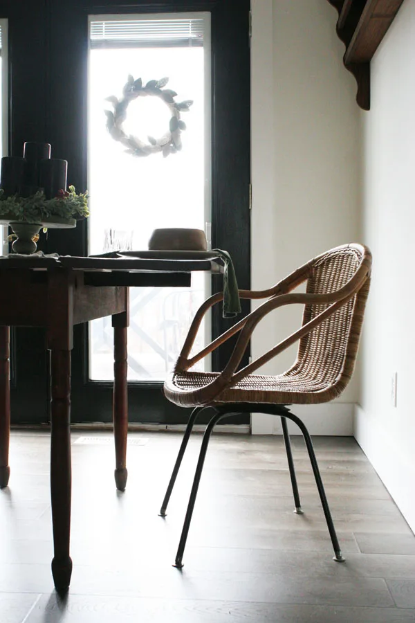 eat in kitchen or breakfast nook with black french doors, antique table, wicker chairs