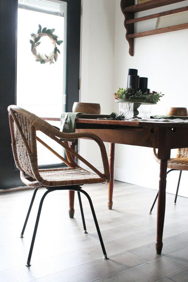 eat in kitchen or breakfast nook with black french doors, antique table, wicker chairs