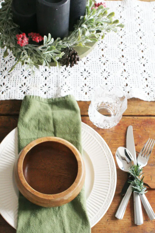 rustic christmas table setting with lace runner and christmas centerpiece