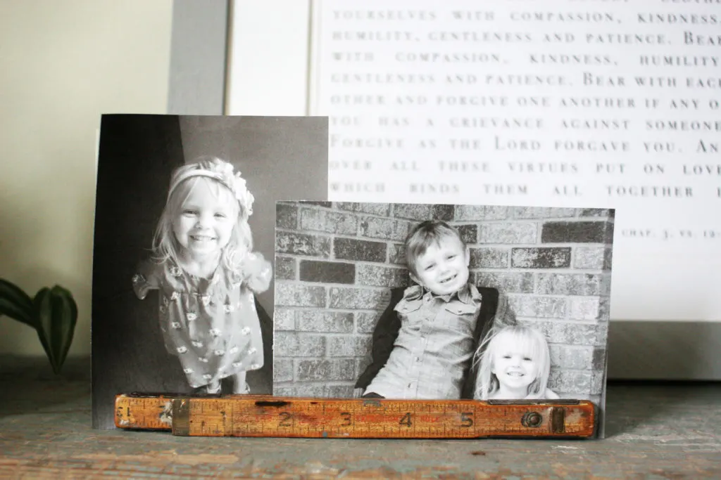family photos in vintage folding ruler on laundry room shelf