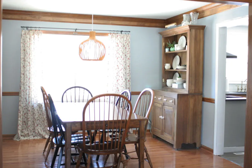 dining room with blue walls and dark wood trim
