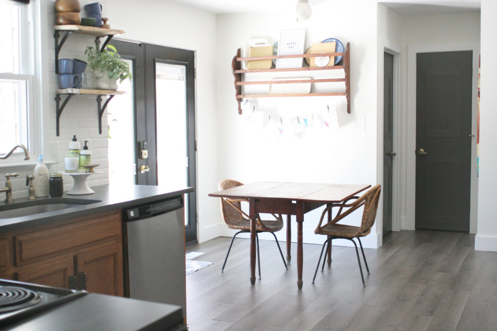 breakfast area with black french doors and an antique plate rack