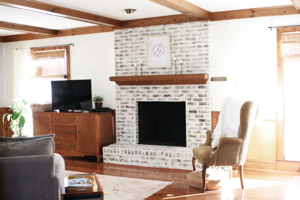 german schmear brick fireplace in living room with wood trim