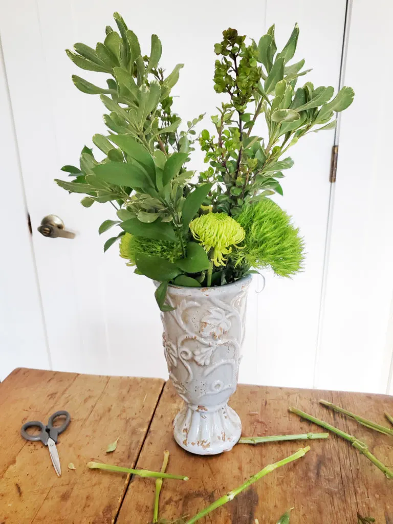 how to assemble a green flower arrangement, step 2, insert tall leafy stems