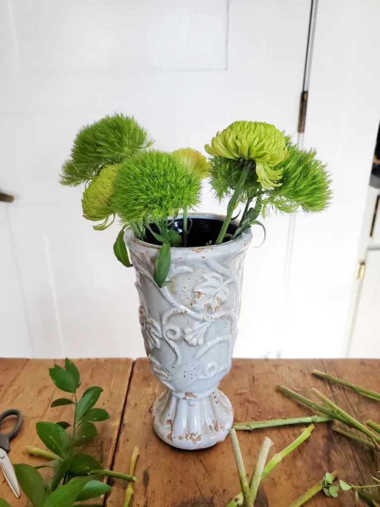 how to assemble a green flower arrangement, step 1, insert short flower stems