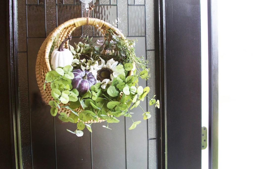fall basket wreath on black front door