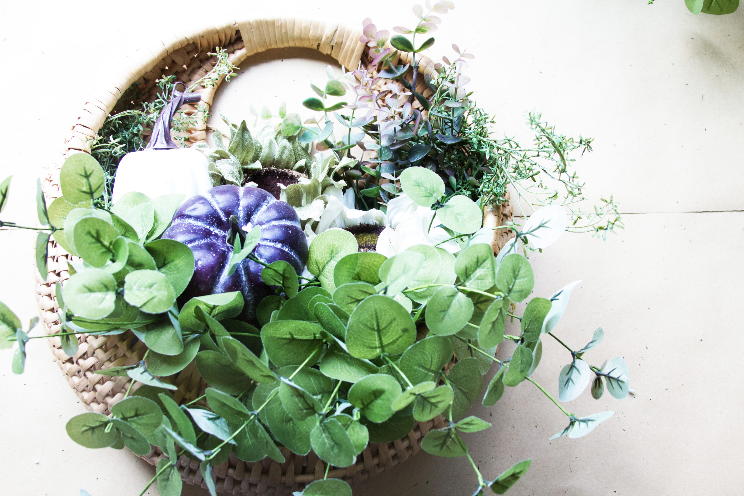 basket wreath with pumpkins and eucalyptus