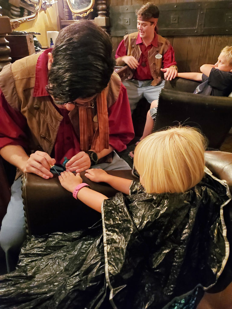 Child getting mermaid makeup and makeover at the Pirates League.