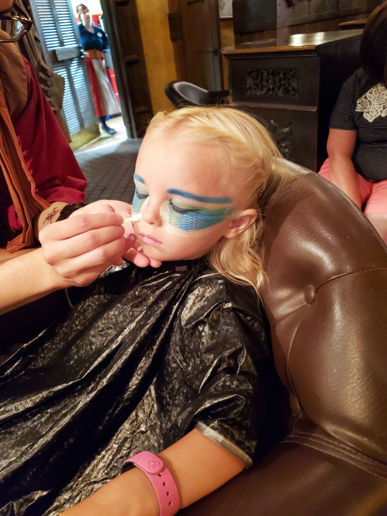 Child getting mermaid makeup and makeover at the Pirates League.