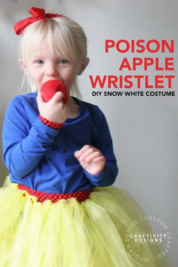 Child dressed for Halloween in a DIY Snow White Costume with a Poison Apple costume prop