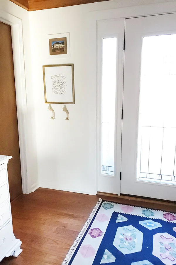 Eclectic entryway with modern coat hooks and wool Romanian rug