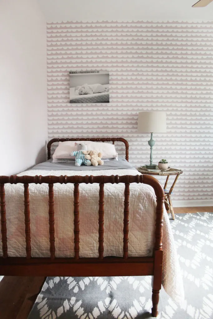 A Pink Girls Bedroom with jenny lind bed, rattan night stand, and gray rug by Craftivity Designs
