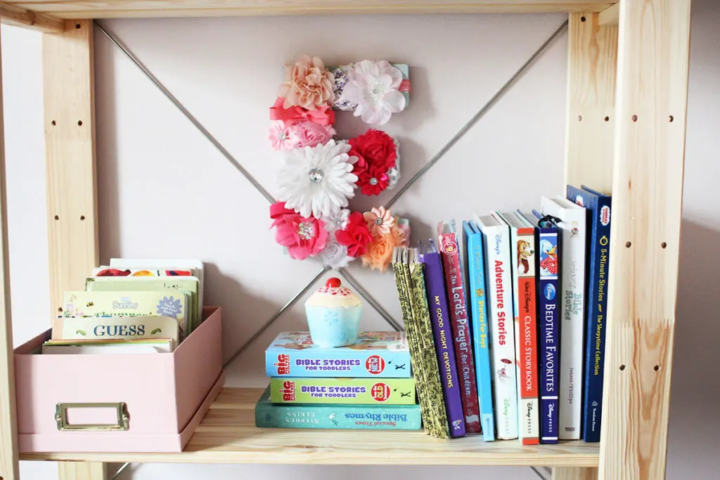 A wood bookshelf with a DIY floral monogram and books - little girl bedroom ideas - by Craftivity Designs