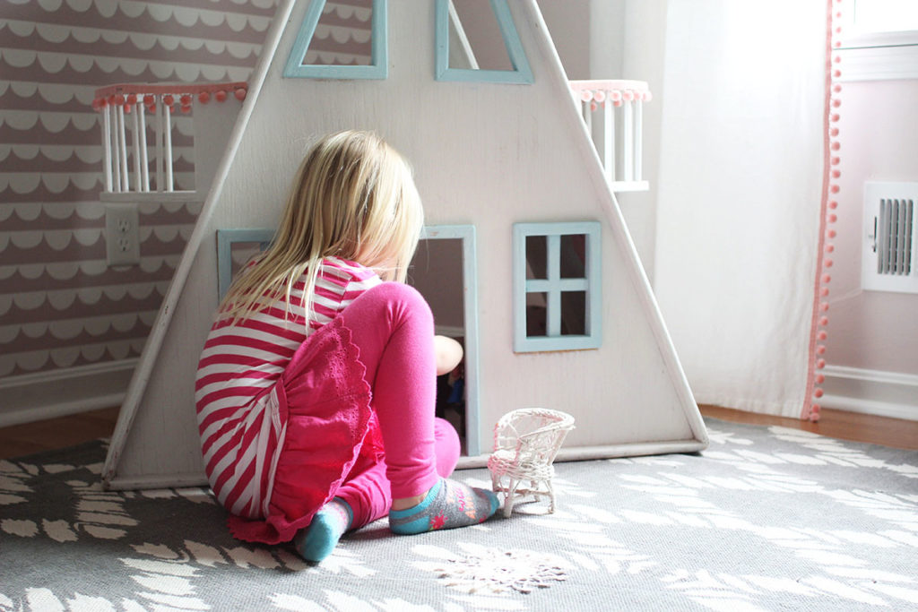 Child playing with wooden dollhouse - by Craftivity Designs