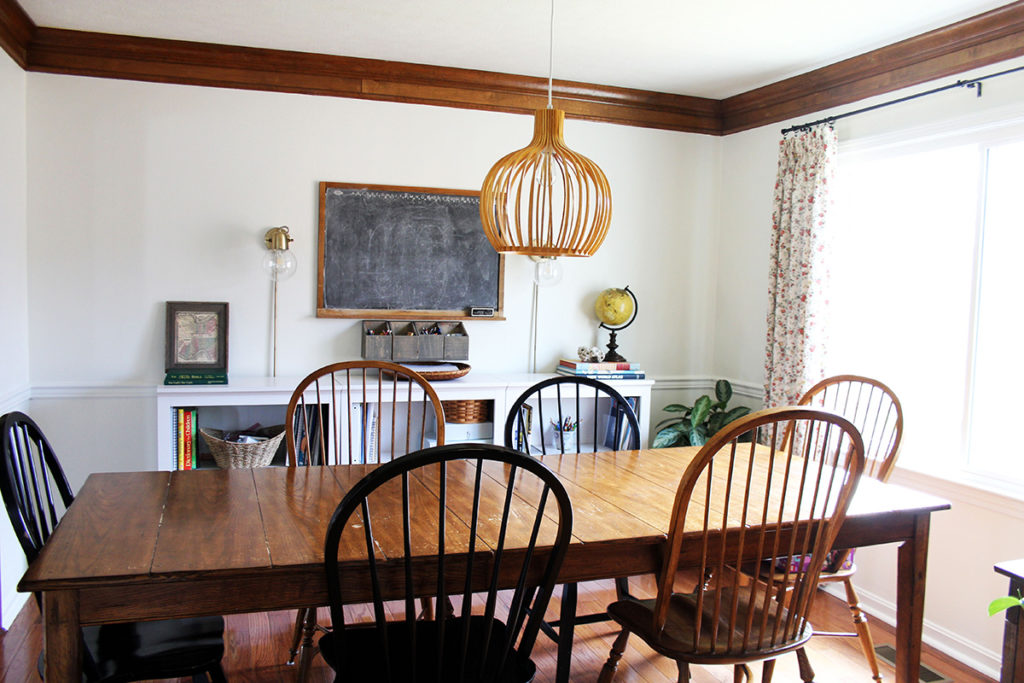 Dining room table in a Homeschool Room with chalkboard and bookshelves