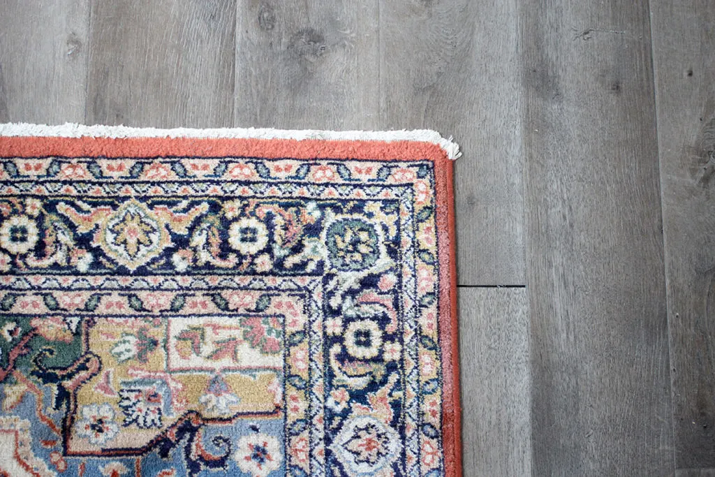 Vintage rug on gray vinyl plank floor