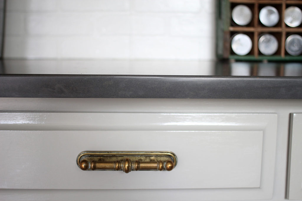 Sherwin Williams Mindful Gray Cabinets in a Kitchen with Brass Hardware