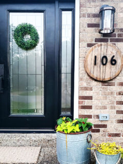 Bourbon Barrel Lid House Number Sign on Brick with Black Door by Craftivity Designs